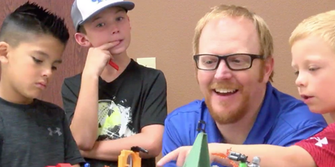 Bobby plays with legos with children