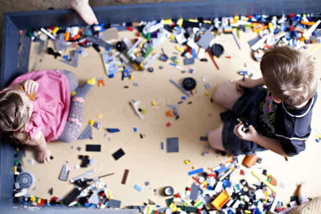 children play with legos on the floor