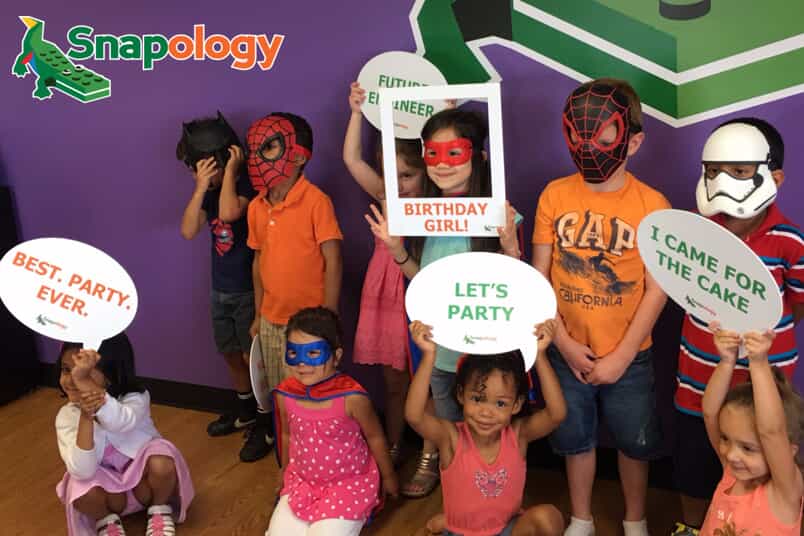 children pose with birthday themed cut outs
