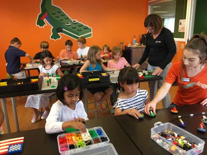 children play with colored lego pieces