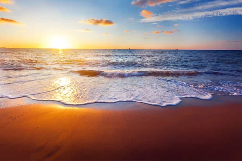 a beach during sunrise