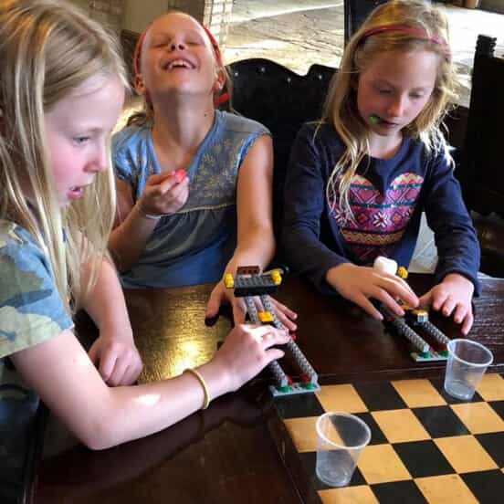 students play with lego catapults