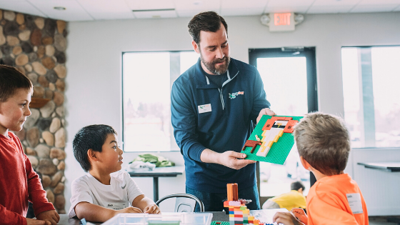 Aaron shows children an image made of perlers