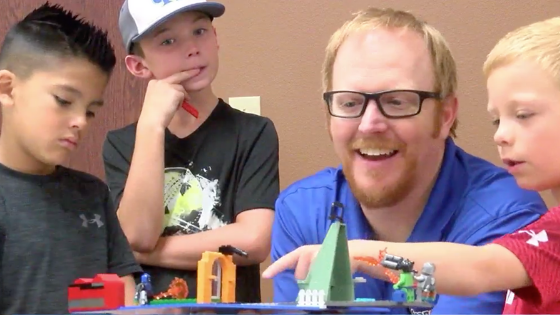 Bobby plays with legos with children